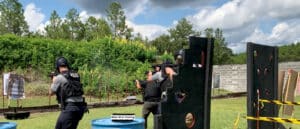 Four police officers engaged in a training exercise with Motoshot Moving Target unit on a shooting range